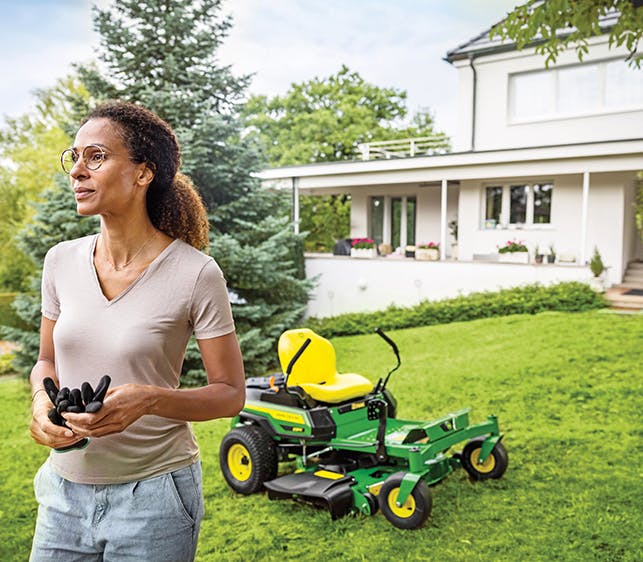 Woman in garden with lawn mower